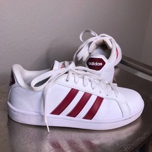 White and red adidas sneakers.